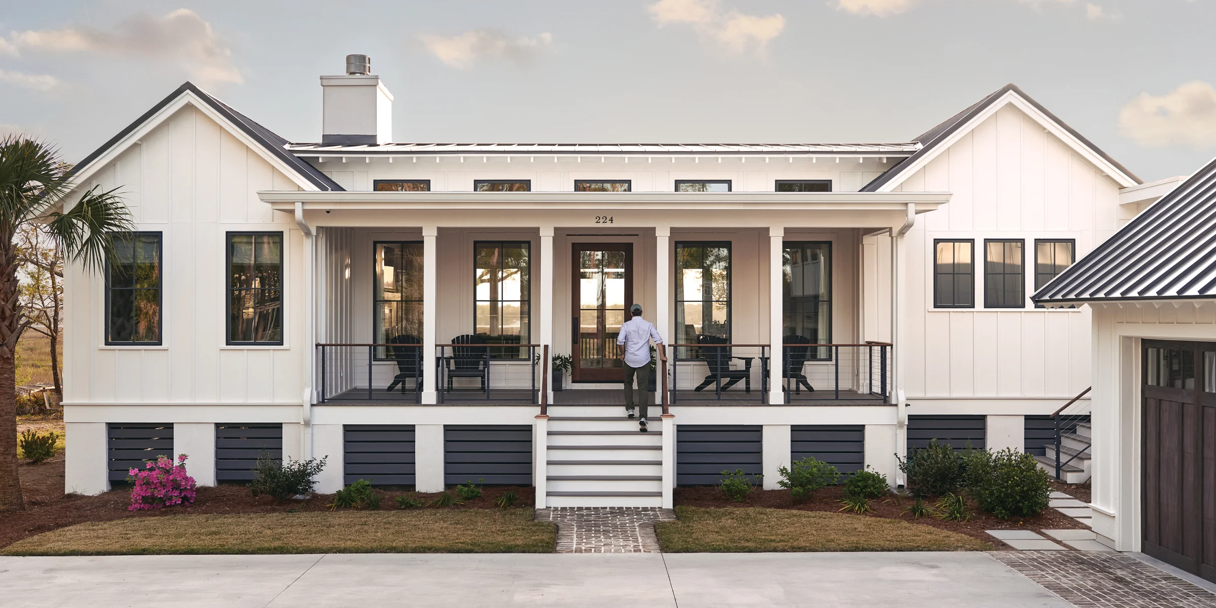 White home with black Marvin Elevate casement windows and a front porch